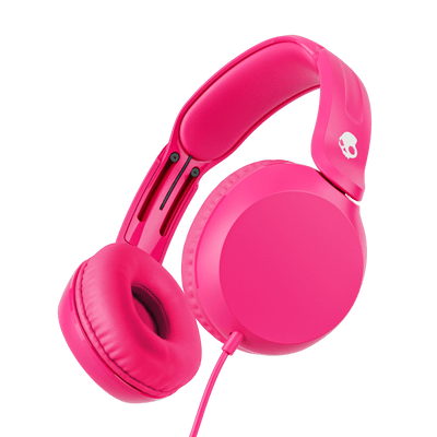 Bright pink over-ear wired headphones shown at an angle against a solid black background. A small white skull logo is visible on the headband. | Crazy Pink