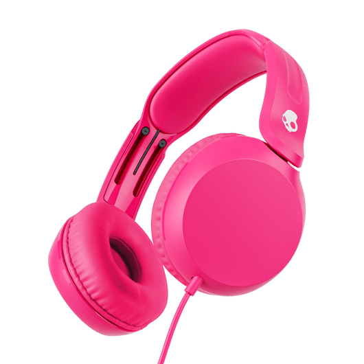 Bright pink over-ear wired headphones shown at an angle against a solid black background. A small white skull logo is visible on the headband. | Crazy Pink
